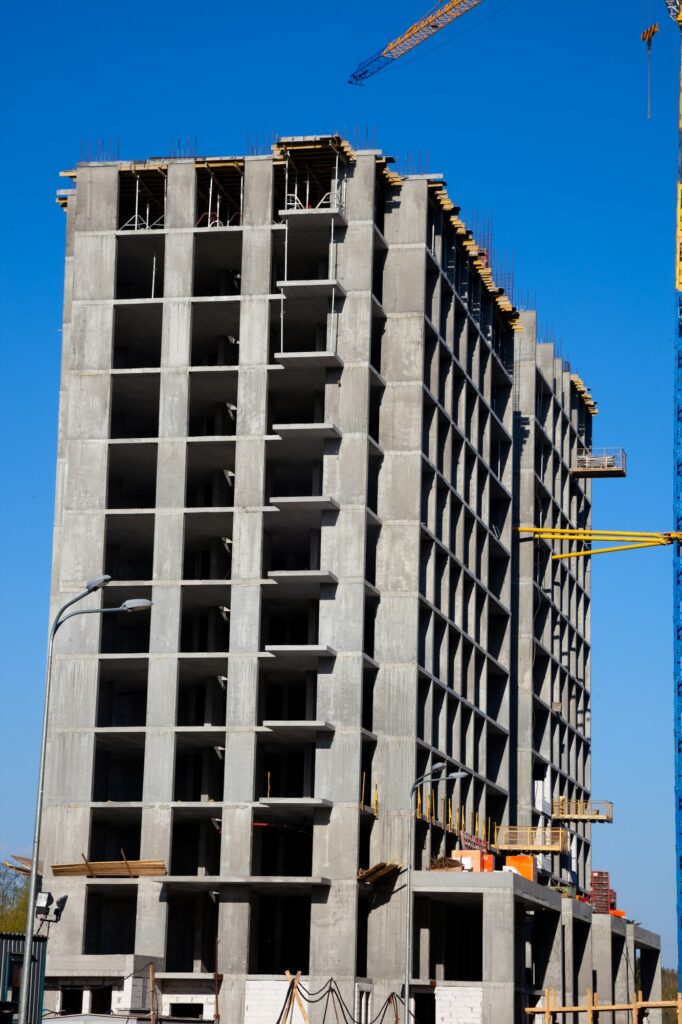 Construction of cast concrete houses. House frame and crane. The construction of high-rise