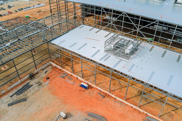 Steel frame truss framework construction of an industrial warehouse building in the construction